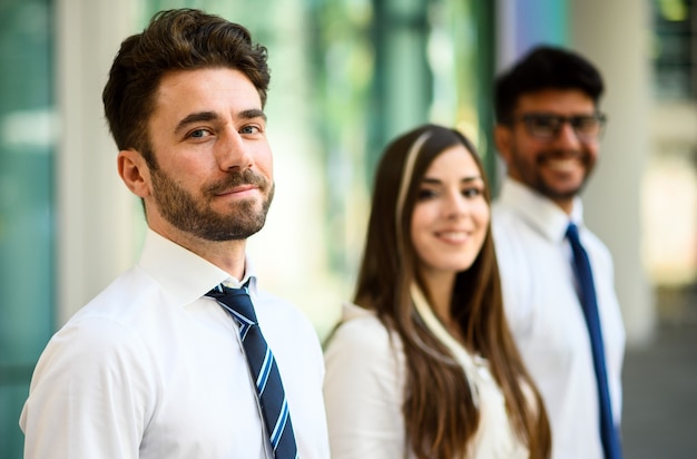 Business team smiling outdoor in a modern urban setting