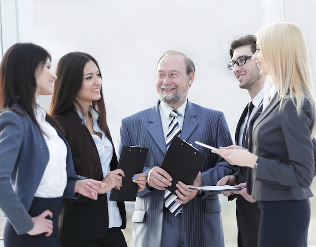 Business team standing talking in the office