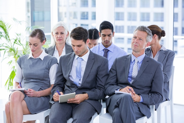 business team taking notes during conference