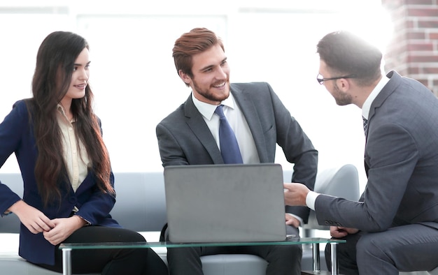 A business team of three planning work in office