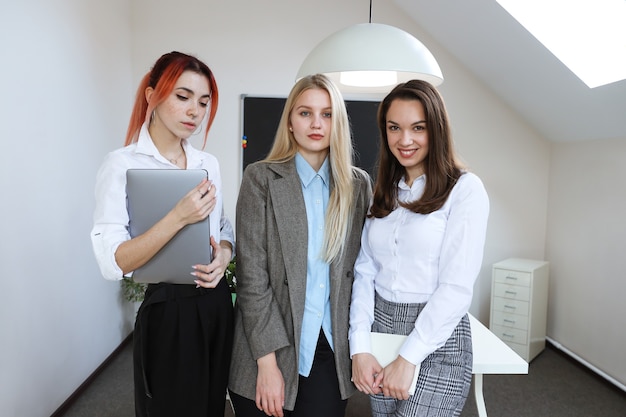 Business team of three young women in the office