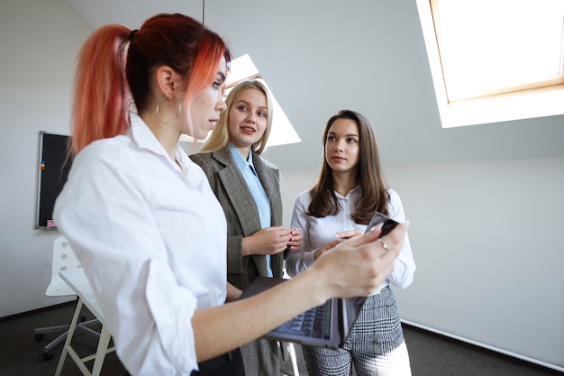 Business team of three young women in the office