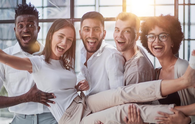 Business team throwing his colleague in office