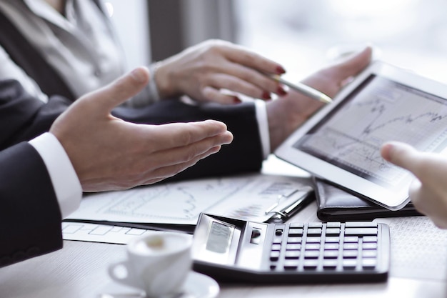 Business team uses a digital tablet to check financial data