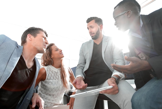 Business team uses a digital tablet to check new data