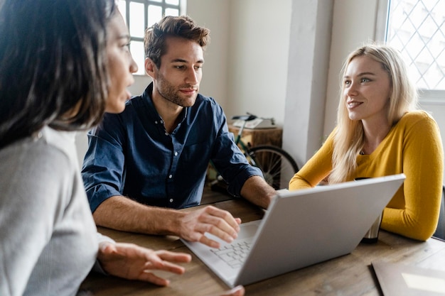 Business team using laptop during a meeting in office