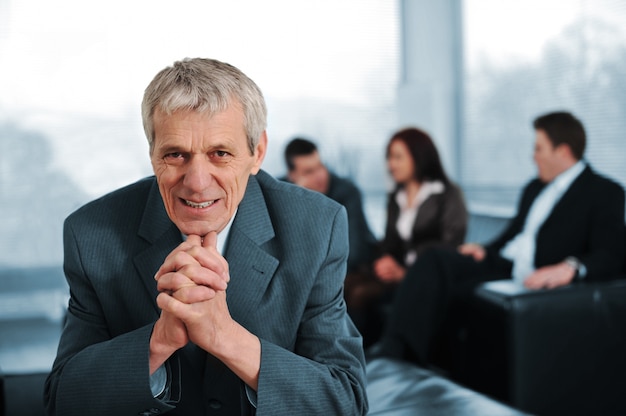 Business team with boss in front of camera