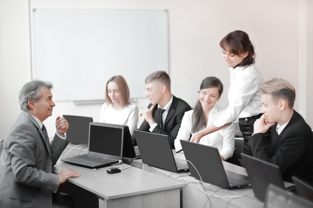 Business team working on laptops in a modern office