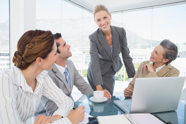 business team working together on laptop
