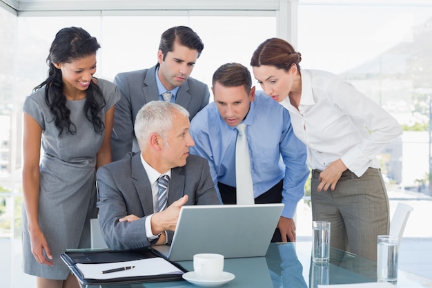 Business team working together on laptop