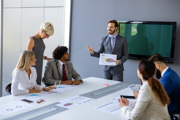 Business team working together on meeting, analyzing financial documents in office