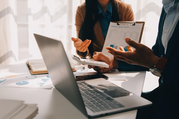 Business team working with new startup project plan and discussion information for financial strategy with laptop and digital tablet in a modern business lounge