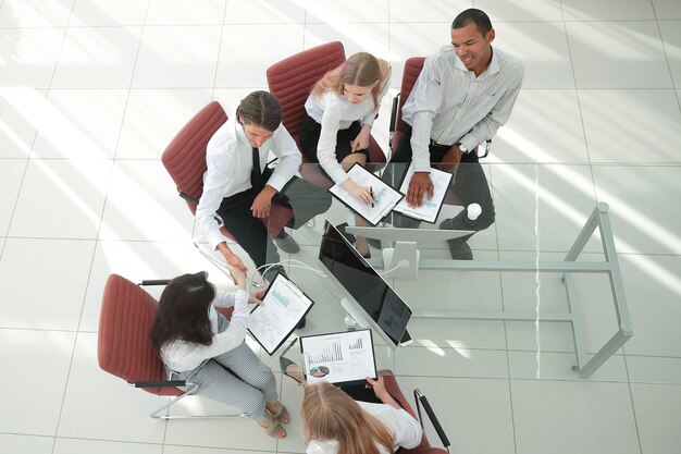 Business team working with papers view from above