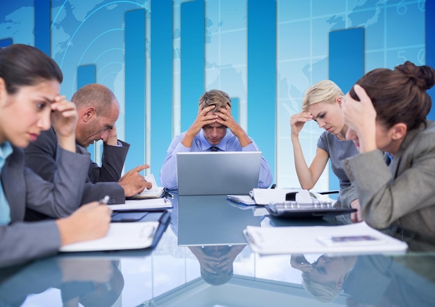 Business team zit aan tafel en kijkt naar werkpapier tegen een blauwe achtergrond