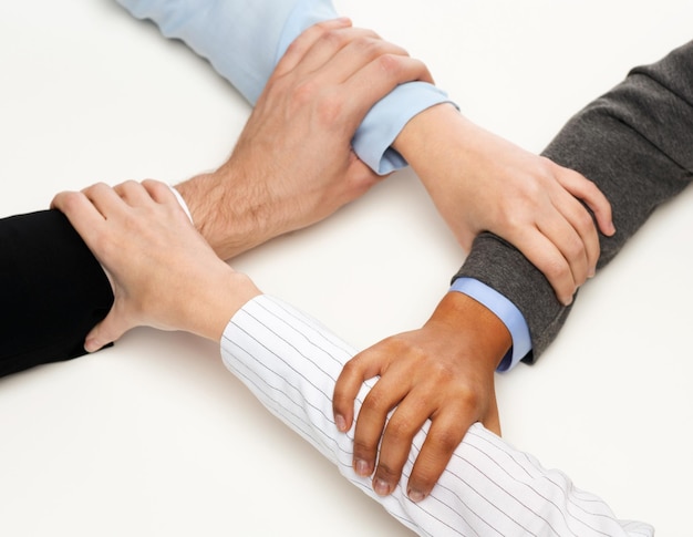 business and teamwork concept - closeup of businesspeople hands united