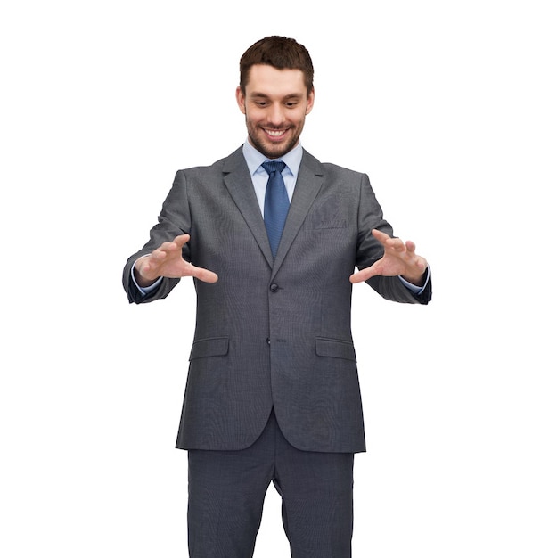 business, technology, communication concept - smiling businessman working with imaginary virtual screen