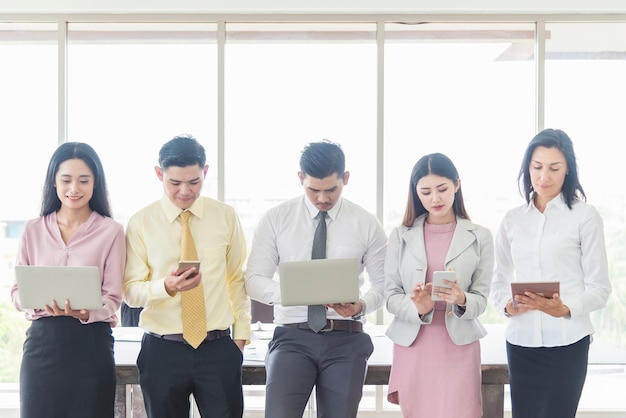 Business and technology concept. Business people using smartphone, tablet and laptop.