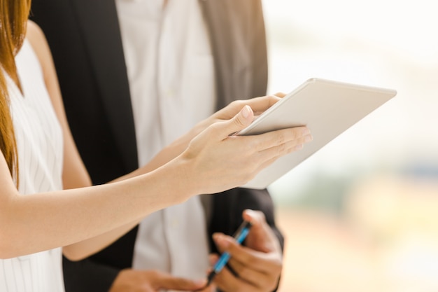 Photo business technology concept businesswomen holding working on tablet