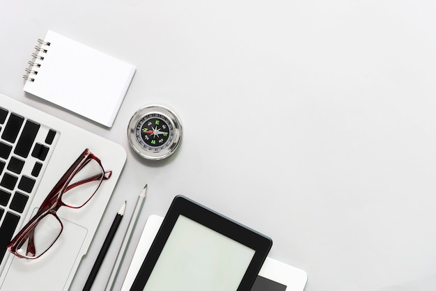 Business and technology concept. closeup of business devices with compass