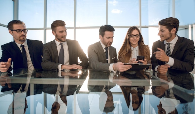 Business and technology concept smiling business team with smartphones in office