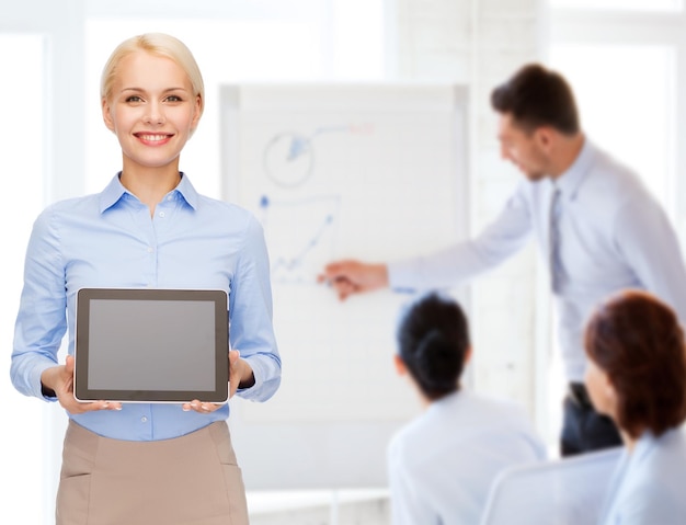 business, technology, internet and advertisement concept - smiling businesswoman with blank black tablet pc computer screen