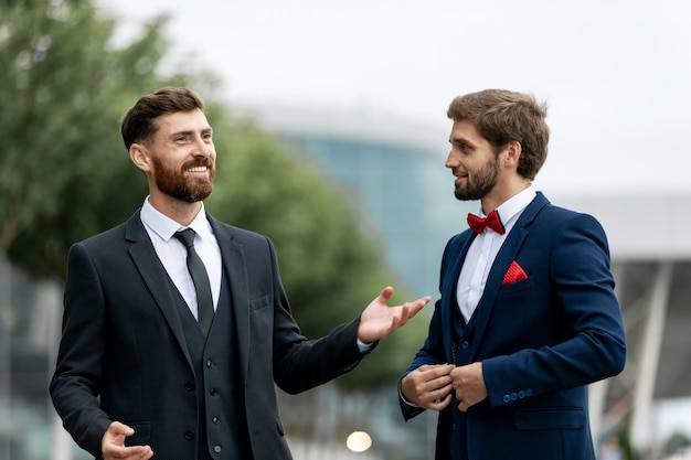 Business, technology and people concept. Image of two young businessmen communicating at meeting