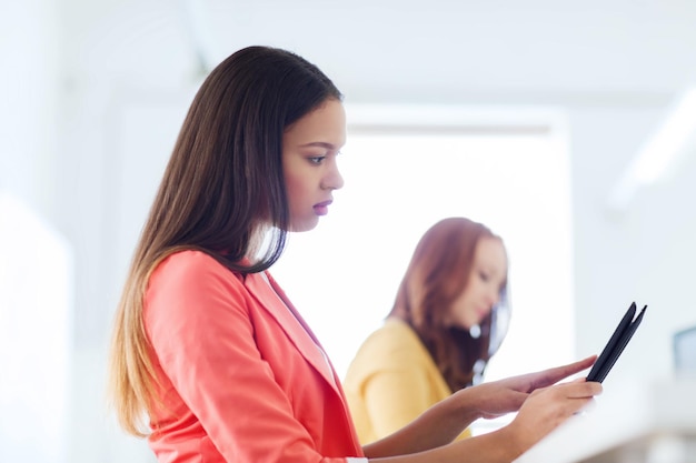 business, technology, startup and people concept - creative african woman with tablet pc at office