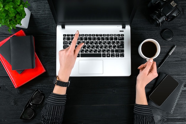 Business and technology topic the hand of woman in a black shirt showing gesture against background ...