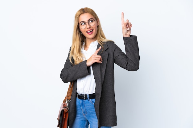 Business Uruguayan woman over isolated white wall pointing with the index finger a great idea