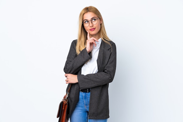 Business Uruguayan woman over isolated white wall thinking an idea