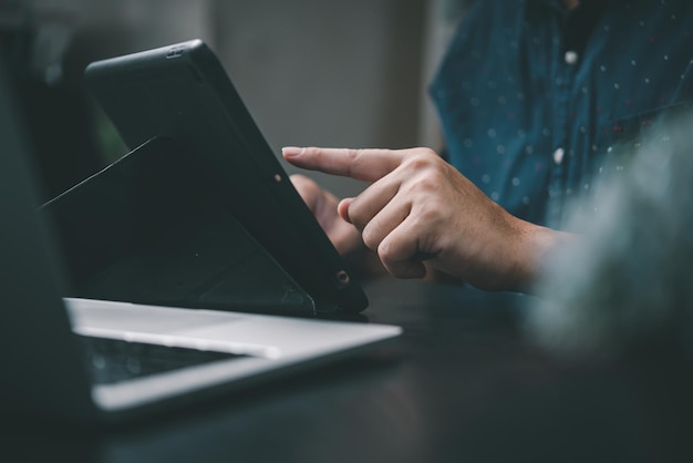 Business using a digital tablet worker touchpad and browsing the internet in an office