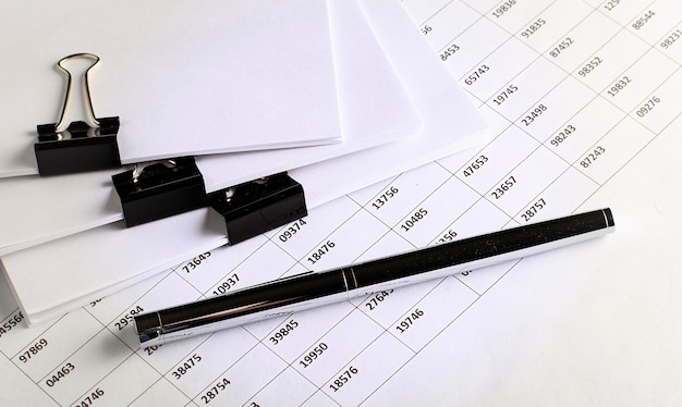 Business view -chart ,pen and papers on white table, concept