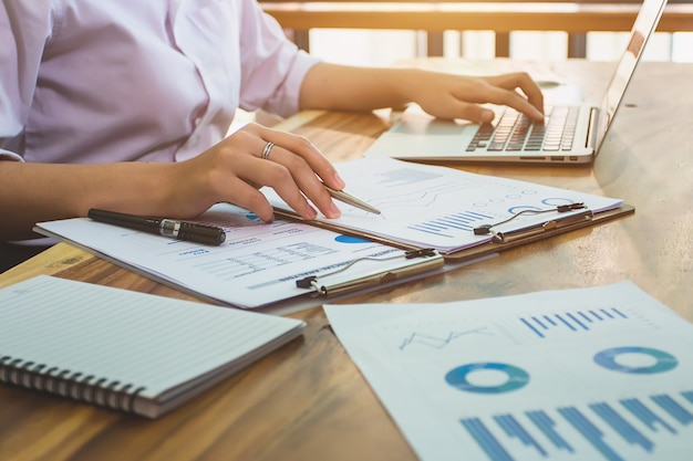 Business woman accountant working with financial reports and laptop computer