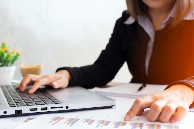 Business woman analyzing investment charts at morning time.