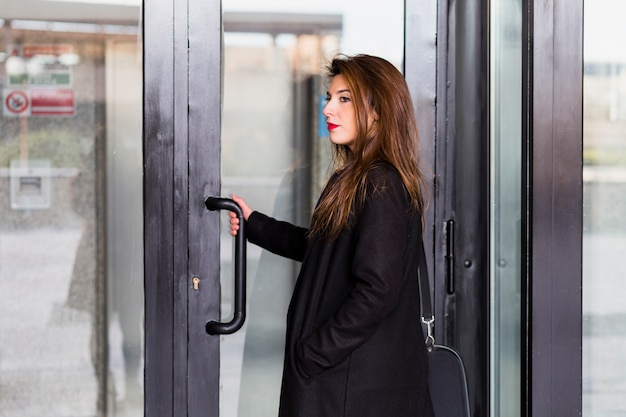 Business woman in black entering building