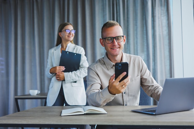 A business woman and a business man are discussing work in the office Modern office Colleagues in the office