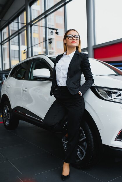 Business woman buys a car at a car dealership