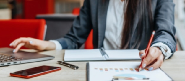 Business woman checks charts and refreshes financial progress. the girl analyzes the business model in the workplace.