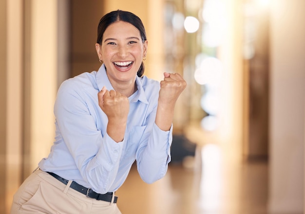 Business woman cheering with fist for success winning and bonus achievement in startup agency Portrait of happy lucky and excited sales worker for celebration deal trading motivation and joy