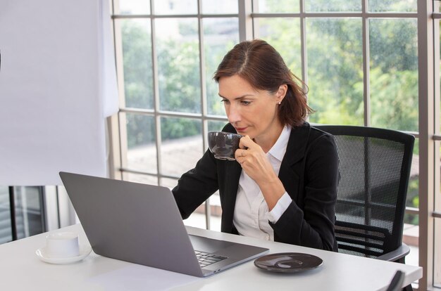 Business woman drinking coffee in office, Meeting - Manager Discussing Work With His Colleagues