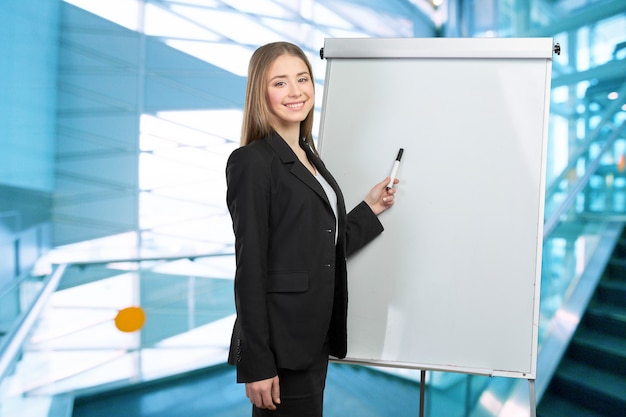 Business woman explain at the whiteboard