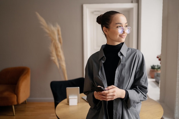 A business woman freelancer shirt an office employee assistant using a phone Workspace in the office