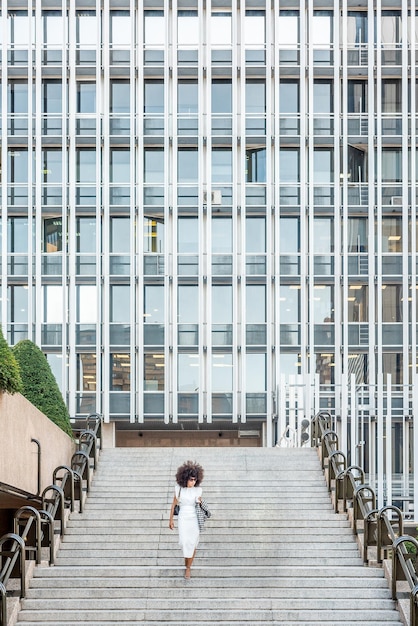 Business woman going down the stairs in the city