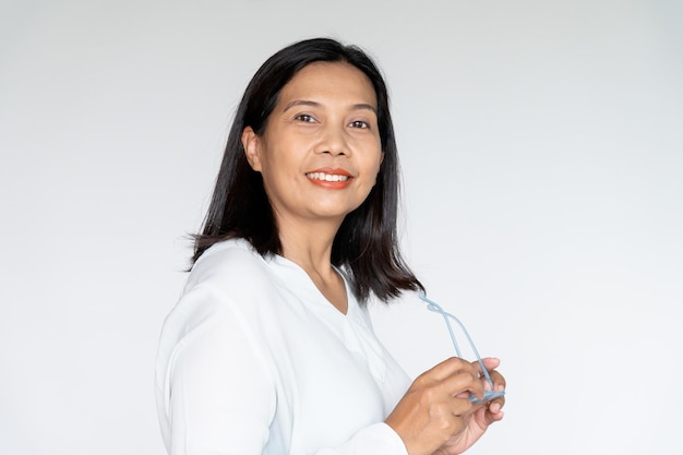 Photo business woman grab her glasses with sincere smiling on white background