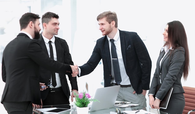 Business woman greets the employee with a handshake