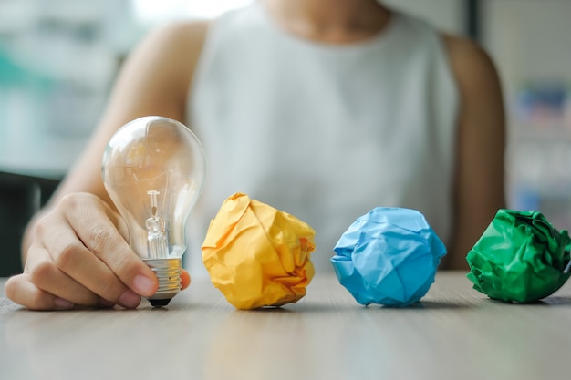 Business woman Hand holding light bulb or lamp 