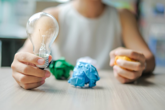 Business woman Hand holding light bulb or lamp  