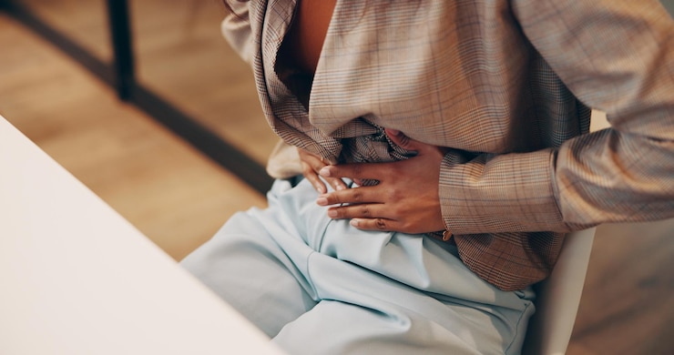 Photo business woman and hands with stomach pain in office for menstrual cramps constipation and digestion problem employee abdomen and endometriosis emergency with uncomfortable ache and gastro health