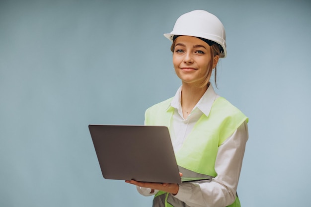 Business woman in hard hat using laptop