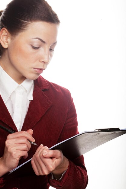 Business woman hold a folder of papers and write